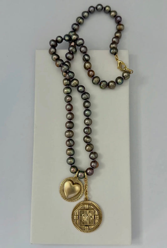 Necklace with brown pearls and gold plated pendant, sewn together with silk. 