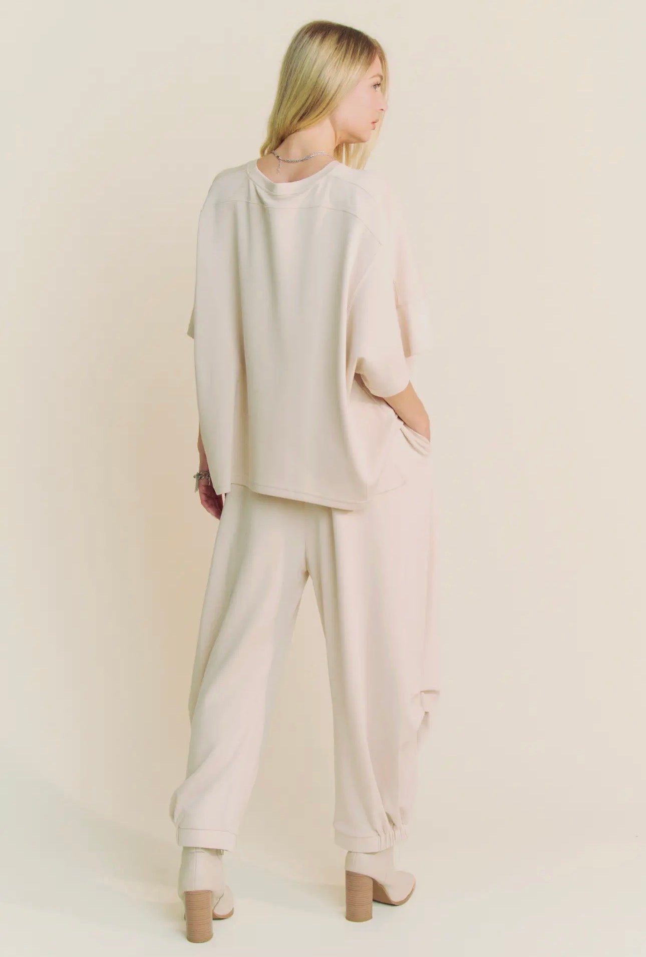 Cream cozy two piece set with barrel style sweatpants and cropped sweatshirt.